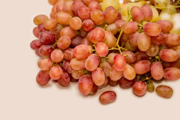 Red and white grapes on neutral background