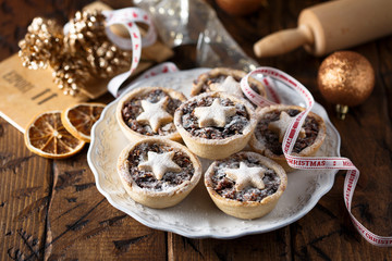 Homemade festive mince pies on white plate © marysckin