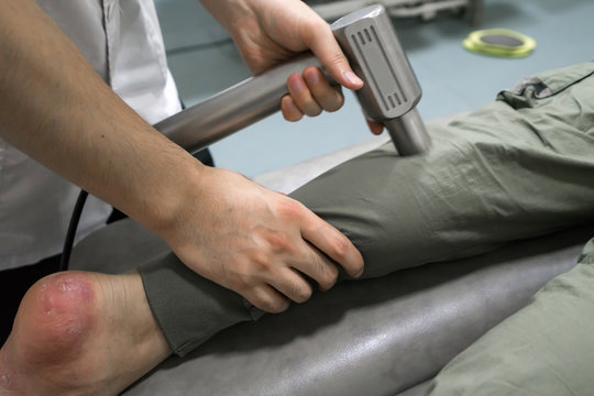 The doctor is rehabilitating the patient's legs