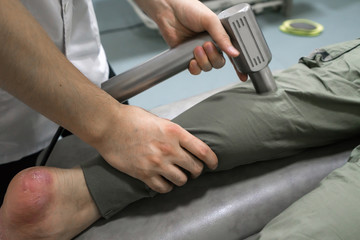 The doctor is rehabilitating the patient's legs