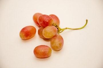 Red ripe grapes on neutral background