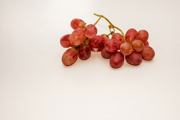Red ripe grapes on neutral background