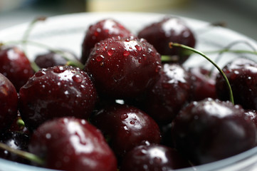 A bowl of dark red wet fresh berries