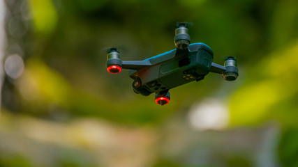 flying drones on green background blurred