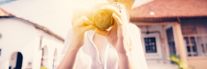 Women's hands with an old camera, retro vintage travel