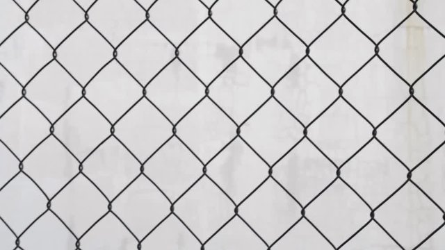 Isolated chain-link fence on white background, panning back and forth
