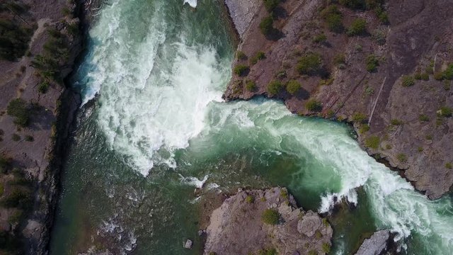 raging waves of the water falls, aerial drone footage, downward view, going downward, Kootenai falls, Montana. v05