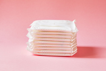 women intimate hygiene products - sanitary pads  on pink background