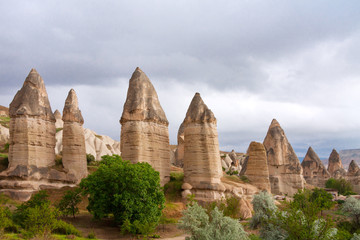 Love valley in Goreme village, Turkey. Rural landscape. Beautiful stone houses in Goreme, Cappadocia. Countryside lifestyle.