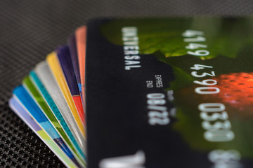 Credit cards are displayed by a fan on a black background.