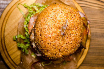 Bacon burger with beef patty on wooden table