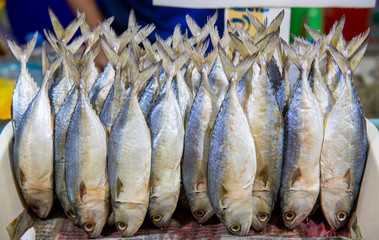 Traditional cut of salted cod on a wooden board . Salted fish, such as kippered herring or dried...