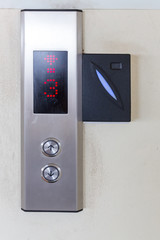 securing lift or elevator access control. elevator access control, Hand holding a key card to unlock elevator floor before up or down. 