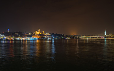 Fototapeta na wymiar Istanbul night panorama viewed form Galata Bridge with the illuminated Suleymaniye Mosque, Turkey