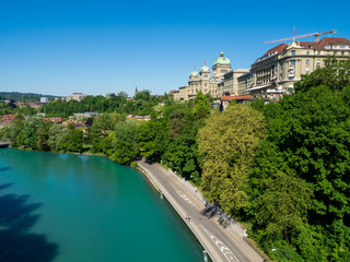 Fototapeta na wymiar Bern, Switzerland - Jun 1st 2019: .The Aare river flows around three sides of the city of Bern. With its crystal-clear turquoise water