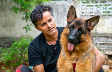 German Shepherd with Handler in Garden