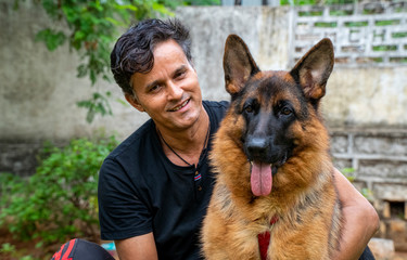 German Shepherd with Handler in Garden