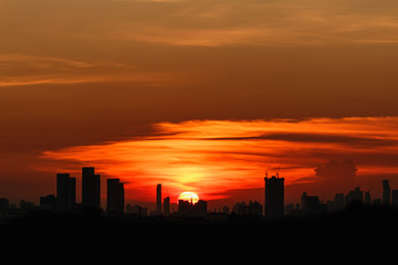 Fototapeta na wymiar Sunset at city of Bangkok with building silhouette in summer,Thailand