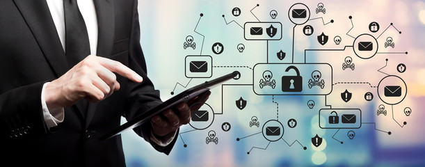 Email virus and scam theme with businessman using his tablet computer