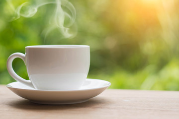 Coffee espresso on wood table nature background in garden,warm tone