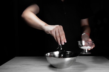 Woman chef sprinkles salt and seasoning for marinated fillet by condiment on a wooden table in the kitchen . Hand sprinkles salt for Preparing healthy food Cooking menu at Home .