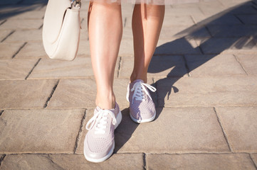  Woman legs, sneakers, handbag, net skirt