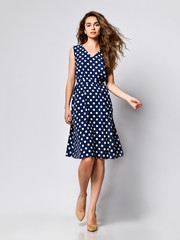 Woman in polka dot Dress in Fashion Store - Portrait of girl in a clothes shop in a midi summer...