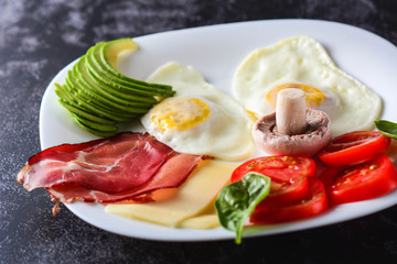Ketogenic food: eggs, avocado, salad, butter. Healthy fats. Selective focus.