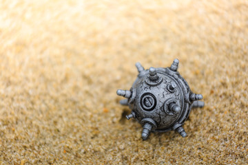 silver color mine toy on the sands