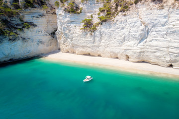 Puglia Landscape in Natural park Gargano - Small boat in beautiful gulf with turquoise water