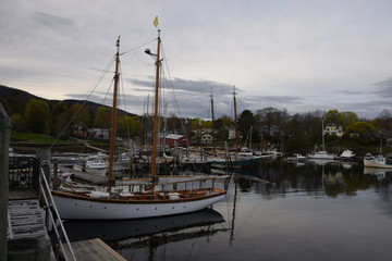 Fototapeta na wymiar Camden Harbor with many antique sailboats in Camden Maine