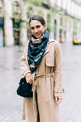 Fototapeta premium Outdoor portrait of young beautiful fashionable woman posing in street.