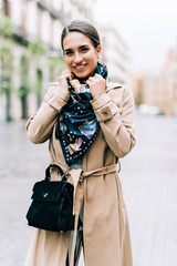 Fototapeta premium Outdoor portrait of young beautiful fashionable woman posing in street.