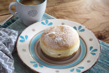 Close up of donuts and coffee cup on wooden table breakfast morning dessert
