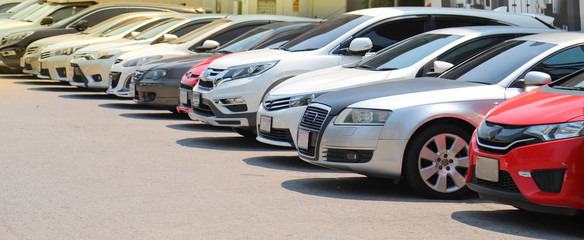 Closeup of front side of  cars parking in outdoor parking lot beside the street beside the street...