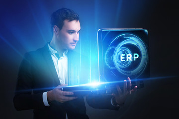 The concept of business, technology, the Internet and the network. A young entrepreneur working on a virtual screen of the future and sees the inscription: ERP