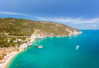 Fototapeta na wymiar Aerial view of popular scenic touristic spot in Puglia, Italy - Faraglioni di Puglia, Baia delle Zagare, Apulia region. Captivating turquoise seascape of Adriatic sea