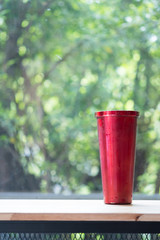 Red stainless steel tumbler with water drop.