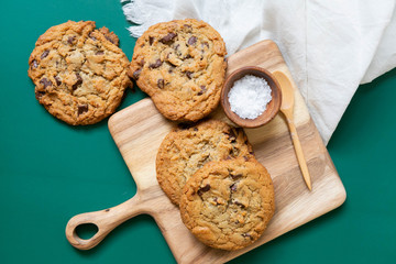 Homemade Salted Chocolate Chip Cookies on Colorful Green Background, Styled Flat Lay Dessert 