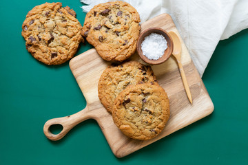 Homemade Salted Chocolate Chip Cookies on Colorful Green Background, Styled Flat Lay Dessert 