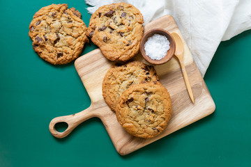 Homemade Salted Chocolate Chip Cookies on Colorful Green Background, Styled Flat Lay Dessert 