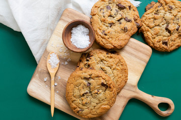 Homemade Salted Chocolate Chip Cookies on Colorful Green Background, Styled Flat Lay Dessert 