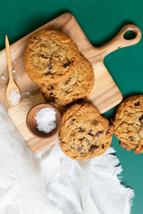 Homemade Salted Chocolate Chip Cookies on Colorful Green Background, Styled Flat Lay Dessert 