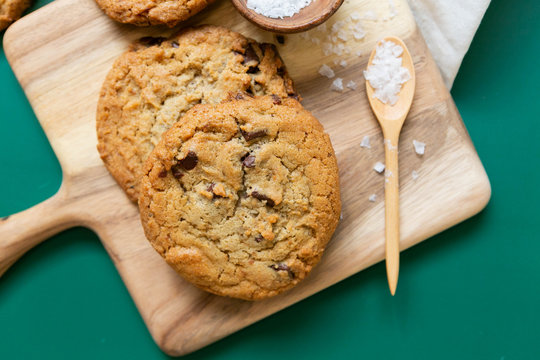 Homemade Salted Chocolate Chip Cookies on Colorful Green Background, Styled Flat Lay Dessert 