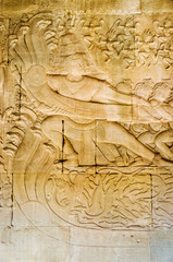 Story of Asura Churning the Ocean of Hinduism Mythology on the Stone Wall Carving inside of Angkor Wat at Siem Reap Province, Cambodia.