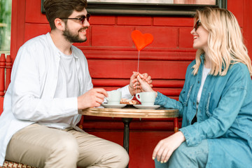 Beautiful happy couple having date in outdoor cafe