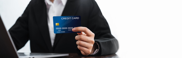 Business woman holding credit card and laptop computer with shopping online. Pay online for convenience