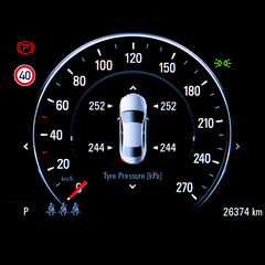 Close up of TPMS (Tyre Pressure Monitoring System) monitoring display on car dashboard panel. The...