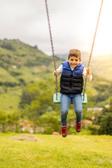 Swinging child on the middle of a field