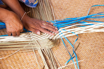 Hand working on bamboo weaving.  